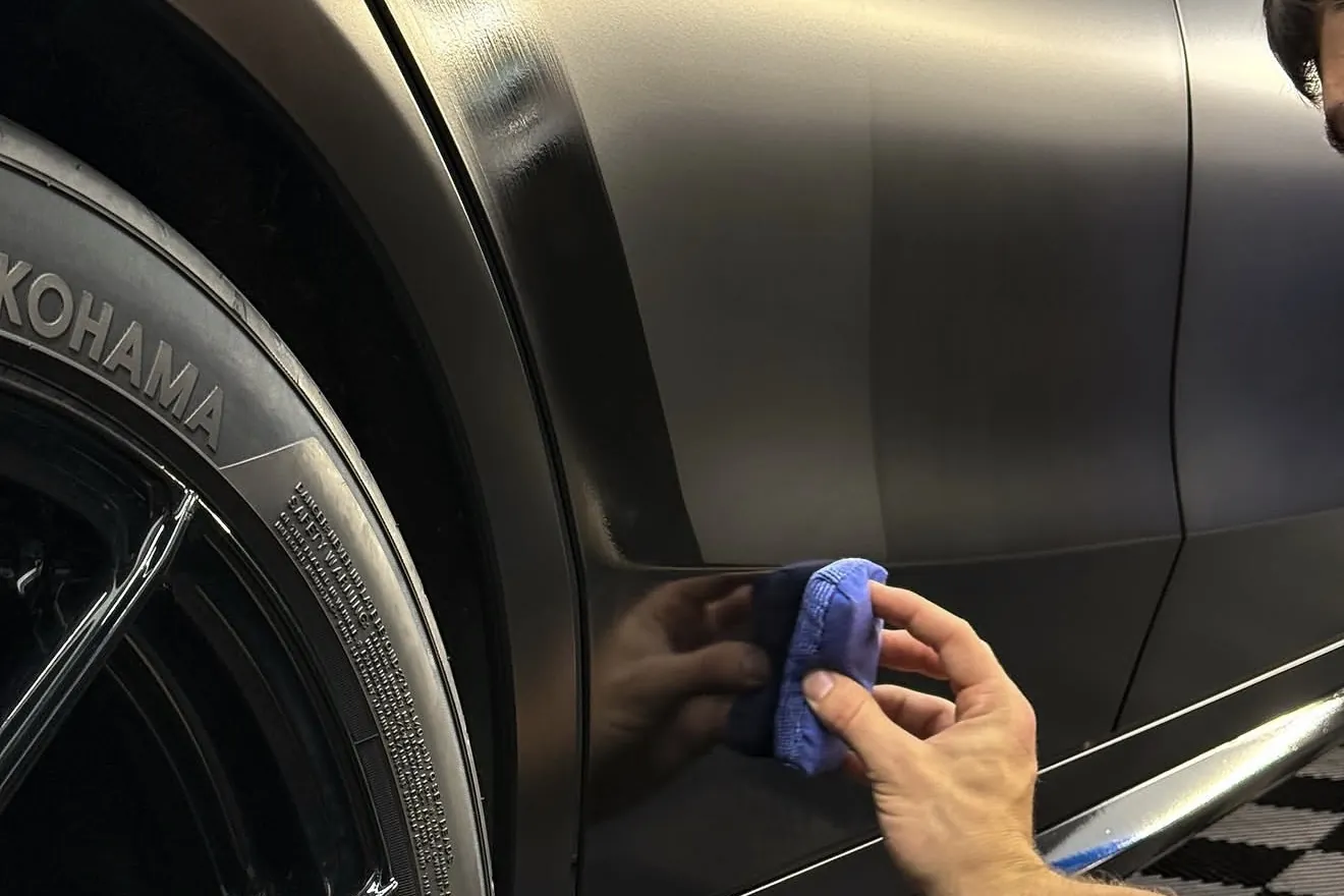 Auto Aesthetics applying a ceramic coating by hand to a satin grey vehicle panel near Binghamton, NY