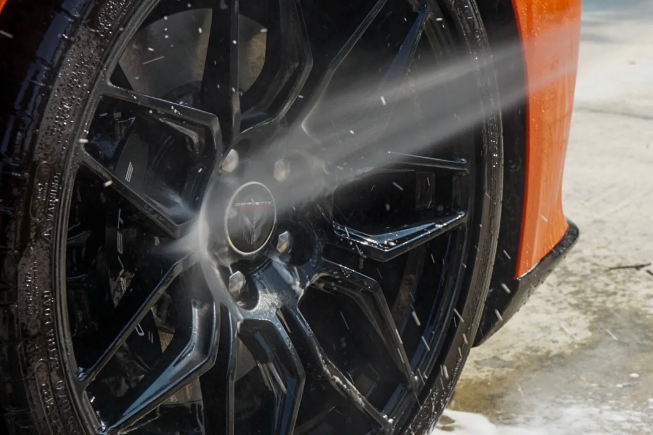 Rinsing a wheel during ceramic coating prep on a Corvette near Binghamton, NY