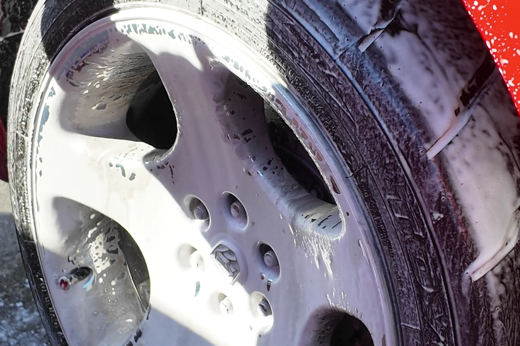 Foam on the wheel and tire during the wheel stage of a full car detail