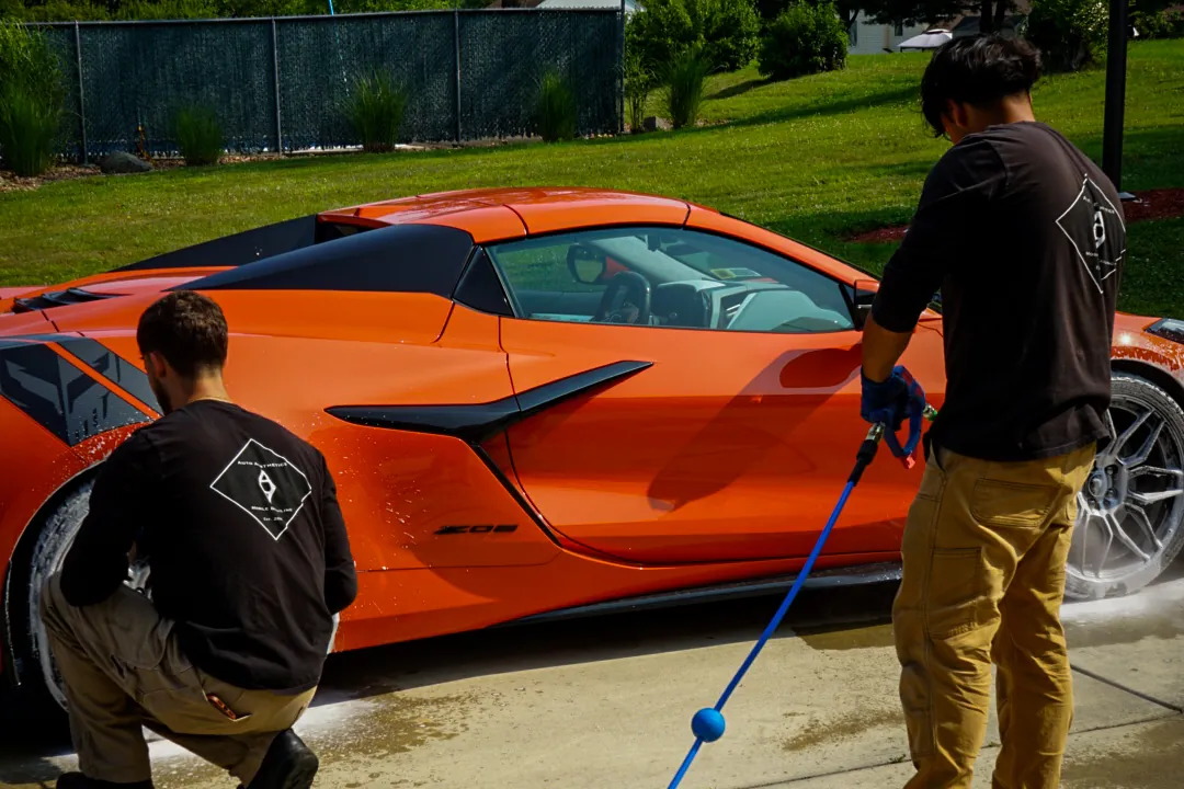 Auto Aesthetics detailing a customer Corvette on site in a driveway during a monthly plan visit near Binghamton, NY
