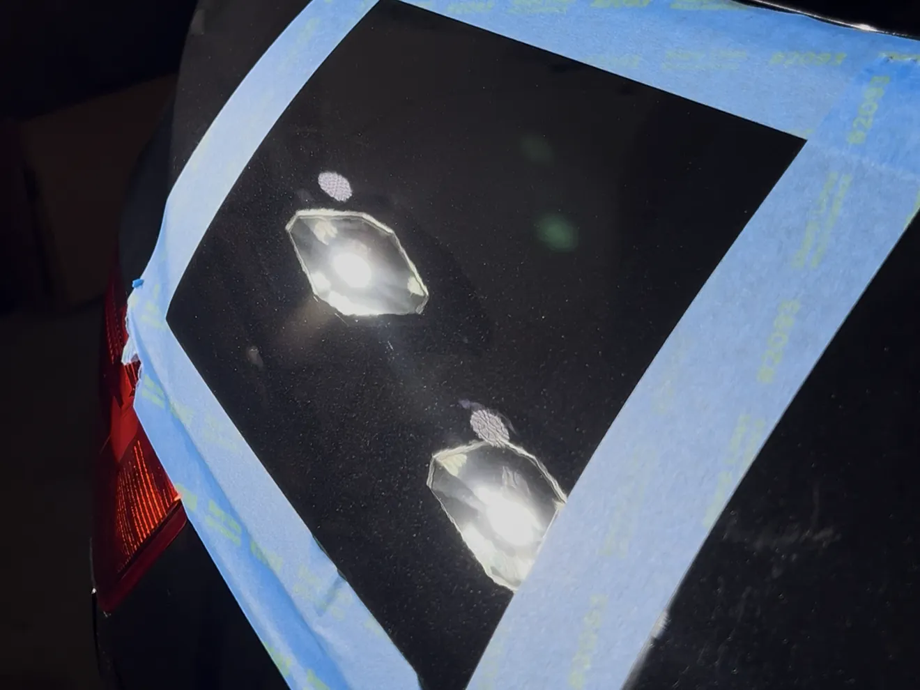 The same taped off test section after machine polishing, with the swirl marks removed and the inspection lights reflecting cleanly, near Binghamton, NY