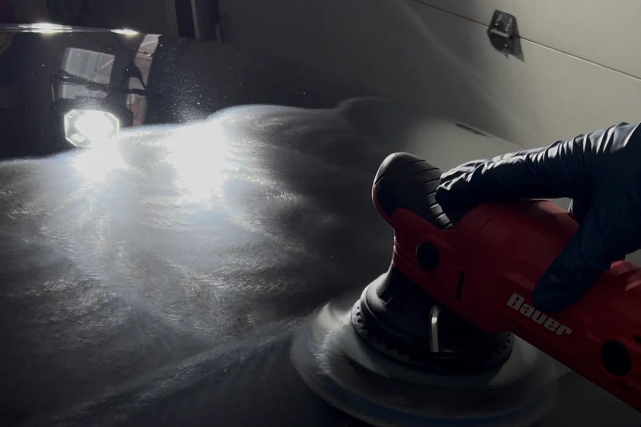 Machine paint correction in progress: a dual action polisher refining black paint during an Auto Aesthetics detail near Binghamton, NY