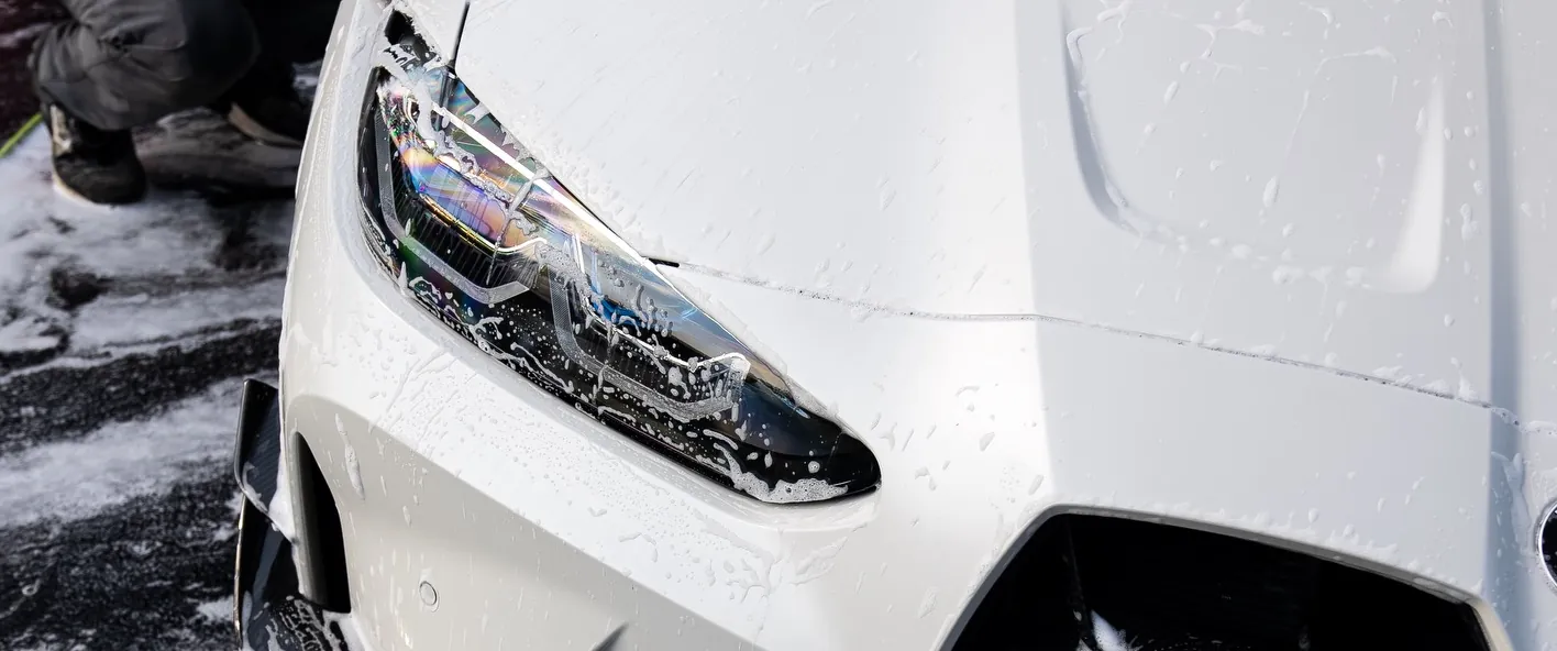 Auto Aesthetics washing a vehicle panel during a mobile detail in Broome County, NY